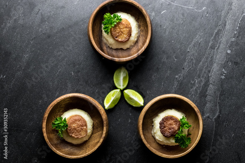 Scallops on Mashed Potatoes with Lime on Slate