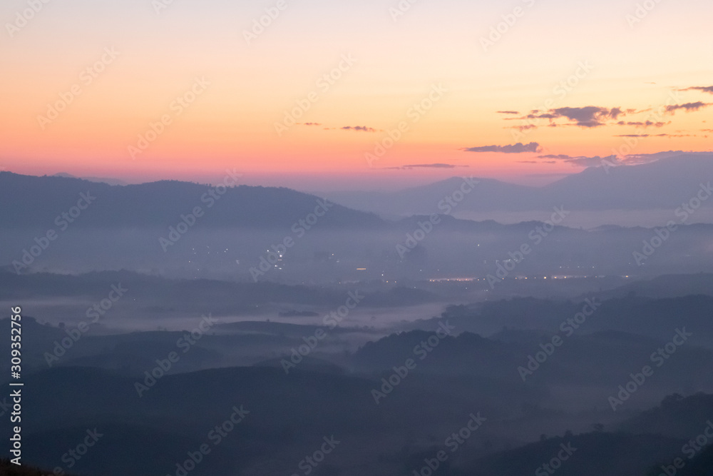 Mountain fog in morning sunrise landscape.beautiful view of mountain range in the mist background.Mountain valley texture in chiang rai northern province of thailand