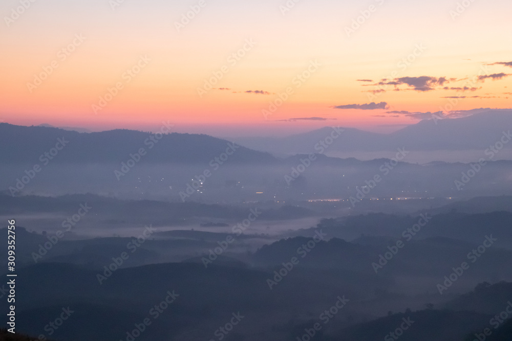 Fototapeta premium Mountain fog in morning sunrise landscape.beautiful view of mountain range in the mist background.Mountain valley texture in chiang rai northern province of thailand