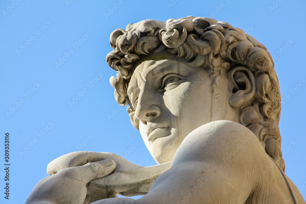 Replica of Michelangelo's David statue against blue sky, Florence, Italy