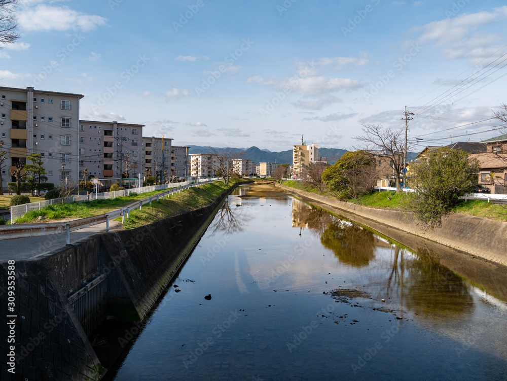 View of stream and riverside buildings in Fukuoka city, JAPAN.