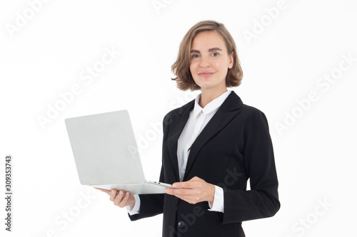 Portrait of young business woman holding laptop with hand pointing up , isolated on white background © Karlie Studio
