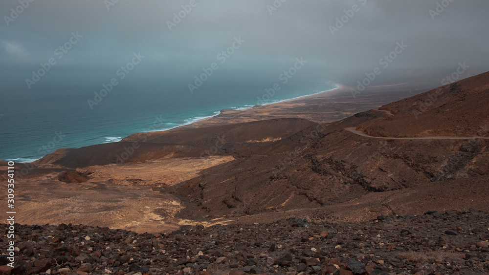 Ethereal landscape of Playa de Cofete, as seen from a high up viewpoint, barren, volcanic landscape, reached only by off road vehicles or by trekking, Morro Jable, Fuerteventura, Canary Islands, Spain