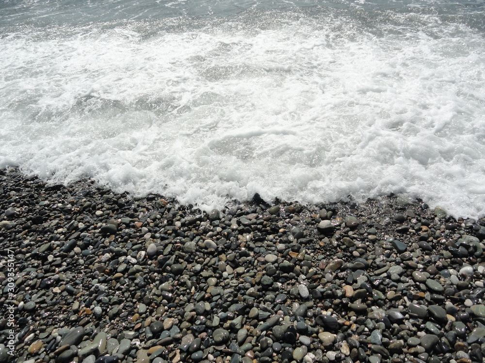 pebble beach and foaming waves of the sea pebble beach and foaming waves of the sea