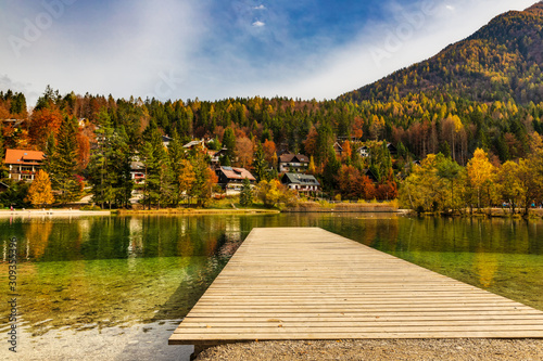 Wooden pier on amazing lake Jasna in autumn season, Slovenian Alps