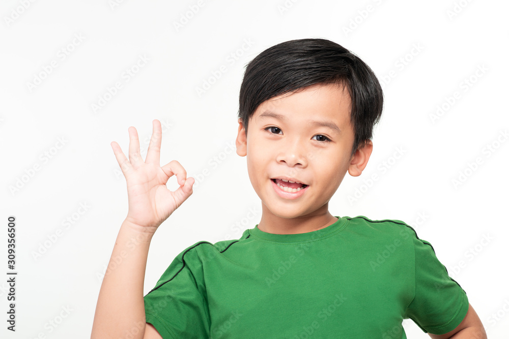 Young smiling boy showing ok isolated on white background Young smiling boy showing ok isolated on white background