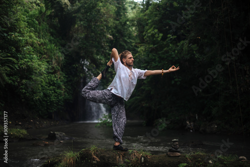 Wallpaper Mural Yoga practice and meditation in nature. Man practicing near river Torontodigital.ca