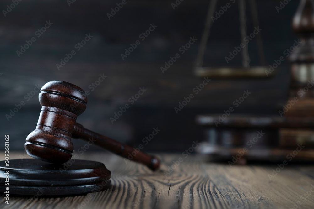 Law concept. Judge’s gavel and scale on dark background. Law concept. Judge’s gavel and scale on dark background.