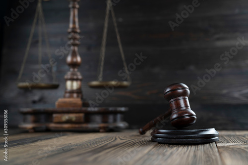 Law concept. Judge’s gavel and scale on dark background.