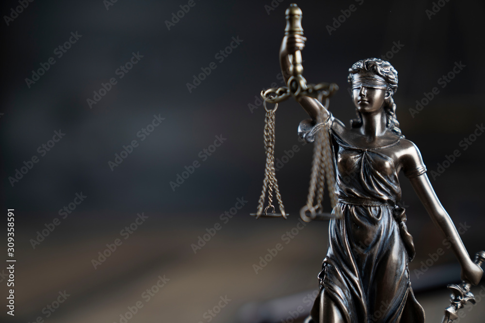 Justice concept. Themis statue  on the rustic wooden table and the dark background. - obrazy, fototapety, plakaty 