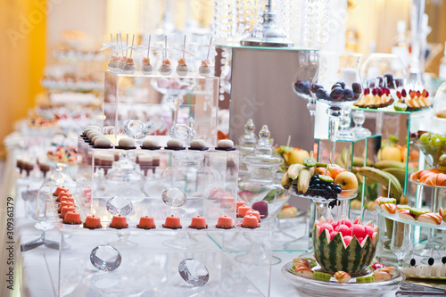 Dessert table of delicious sweets on wedding reception.