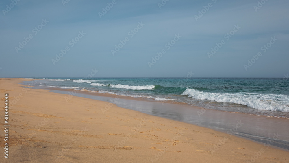 Calm waves washing the pristine beach Playa Jandia, in Fuerteventura, one of the most attractive tourist destinations in the Canary Islands, for its white sandy beaches, mild climate and wild nature