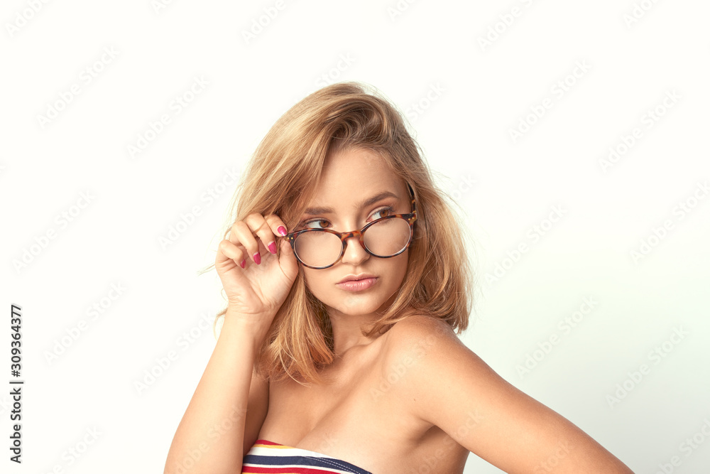 young girl in glasses, beautiful and healthy skin, natural blond hair, empty background, delicate makeup