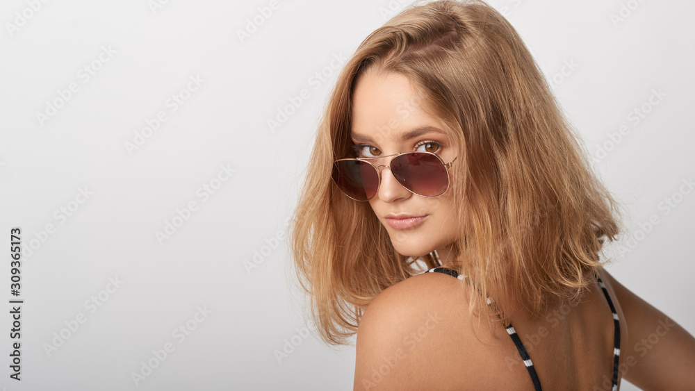 young girl in glasses, beautiful and healthy skin, natural blond hair, empty background, delicate makeup young girl in glasses, beautiful and healthy skin, natural blond hair, empty background, delicate makeup