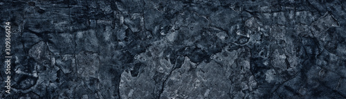 Dark blue weathered broken concrete surface panoramic texture. Old cracked ce...