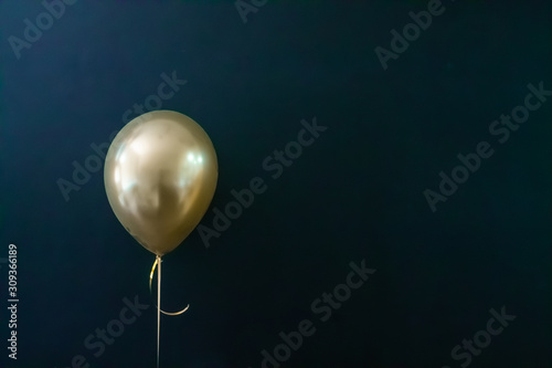 golden balloon on a dark background. Holiday Concept, Postcard