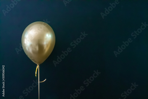 golden balloon on a dark background. Holiday Concept, Postcard