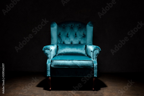 elegant velour blue armchair isolated on black