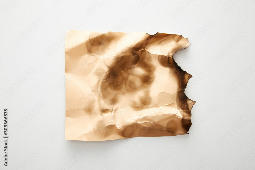 top view of empty crumpled and burnt beige vintage paper on white background top view of empty crumpled and burnt beige vintage paper on white background