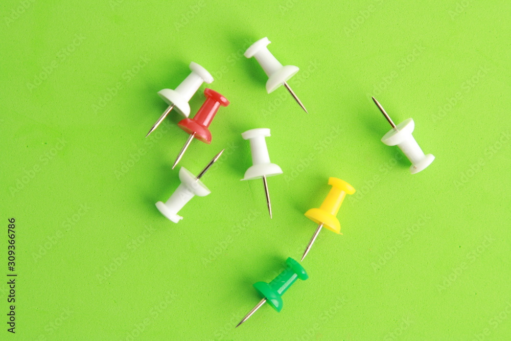 plastic thumbtacks in colorful background