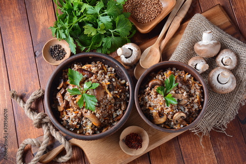 Buckwheat porridge with mushrooms in a bowl. Vegan , gluten-free. Russian or Ukranian cuisine. Healthy food concept