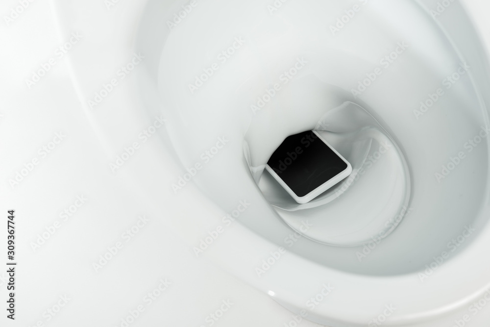 close up view of smartphone in ceramic clean toilet bowl isolated on white close up view of smartphone in ceramic clean toilet bowl isolated on white