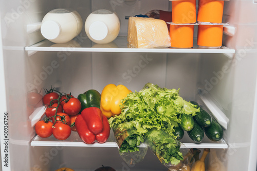 open fridge full of fresh food on shelves
