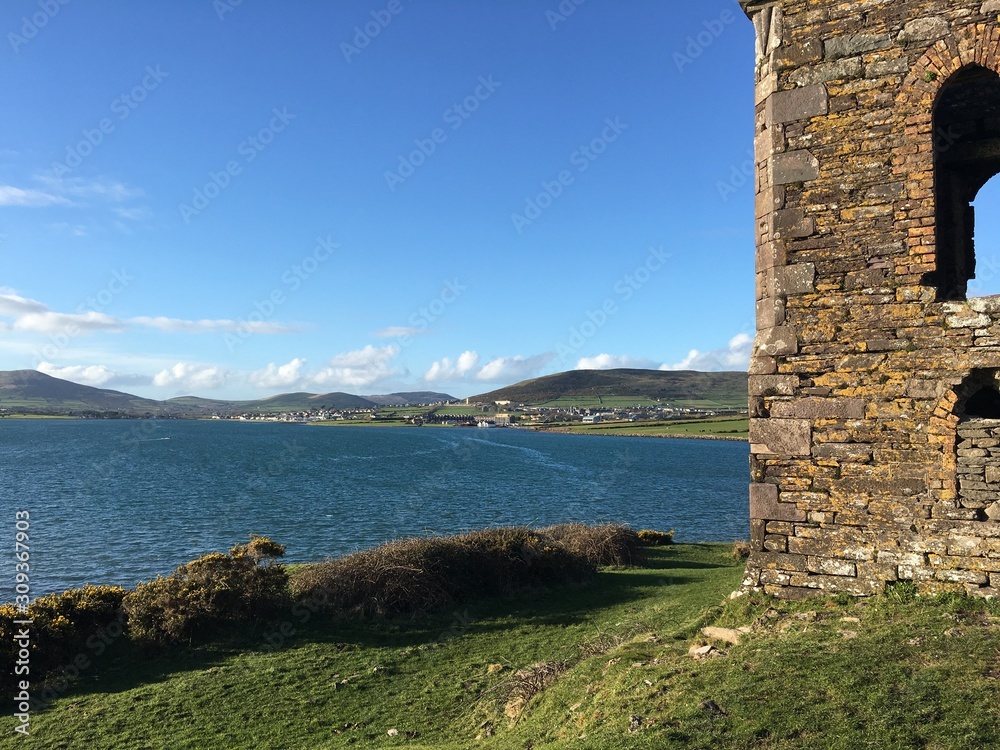 Fototapeta premium Old stony lighthouse by the sea