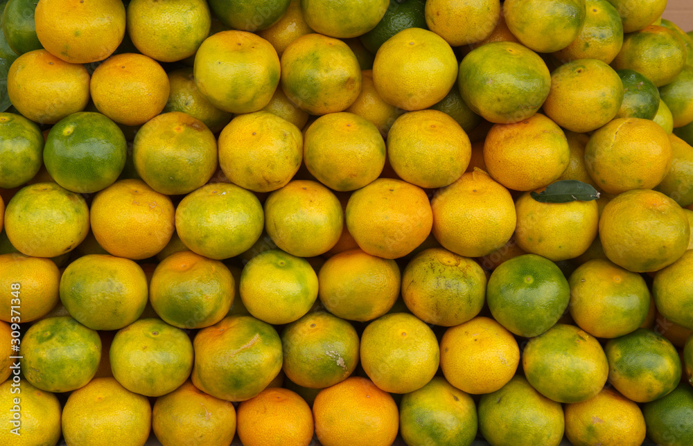 yellow-green Abkhazian tangerines on the market counter yellow-green Abkhazian tangerines on the market counter