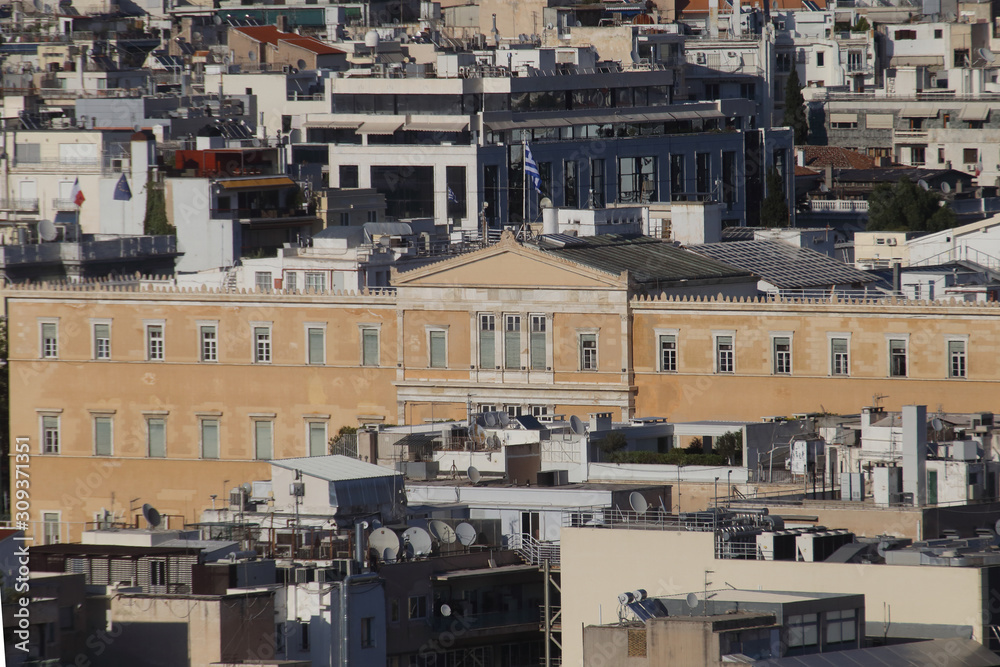 Athens, Greece - July 20, 2019: The seat of the Hellenic parliament photographed from the acropolis Athens, Greece - July 20, 2019: The seat of the Hellenic parliament photographed from the acropolis