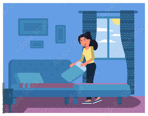 Woman making bed in morning after night sleep