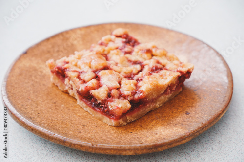 Homemade raspberry crumble bar on plate