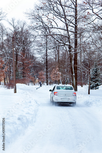 car rides on a snowy road in a park
