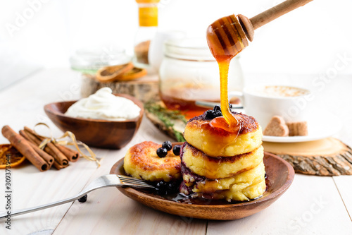 Cottage cheese pancakes with honey. Breakfast or Lunch Concept.