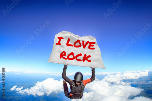 I love Rock. Flag in skydiving. People in free fall.Teampleat skydiver. Extreme sport.