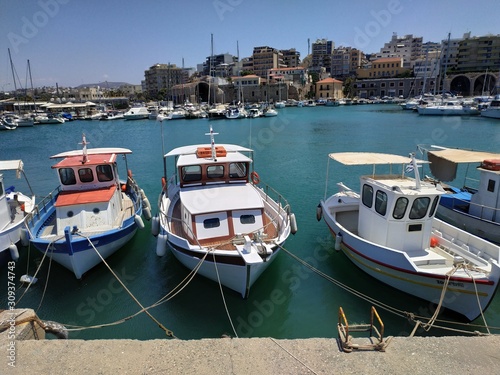 HERAKLION, GREECE - JUNE 27, 2019: casual view on the port side of the city with boats in it