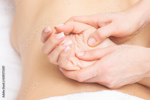 Young woman having arm massage in beauty salon  close up view