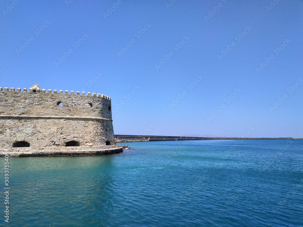 HERAKLION, GREECE - JUNE 27, 2019: casual view on the port side buildings and architecture