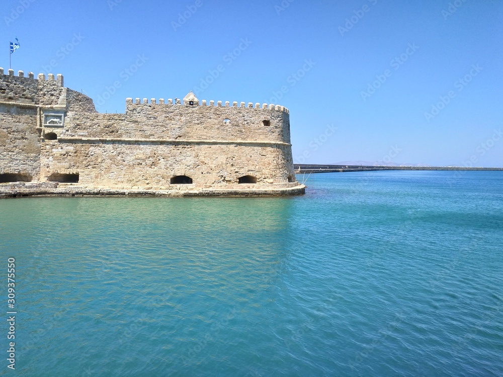 HERAKLION, GREECE - JUNE 27, 2019: casual view on the port side buildings and architecture