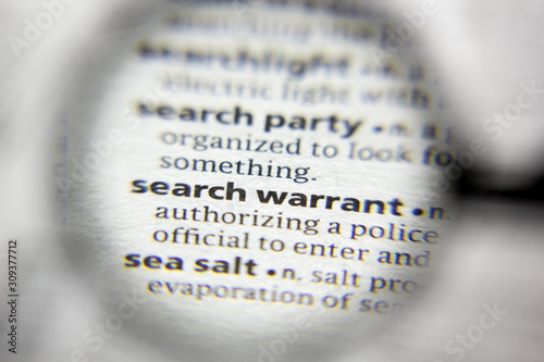 The word or phrase Search warrant in a dictionary. photo