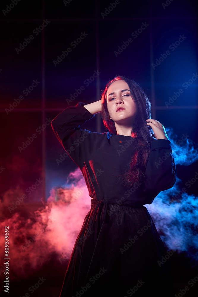 667px x 1000px - Portrait of chubby teen girl during photoshoot with colored smoke at night  and black background Stock-Foto | Adobe Stock