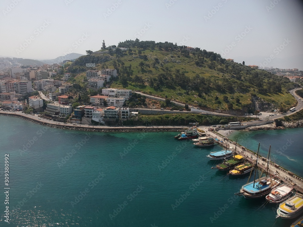 Aerial view on the Kusadasi city port side with boats and buildings in sight