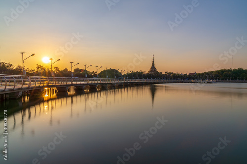 In Khon kaen sunset time at Bueng Kaen nakhon with Wat Phra Mahathat Kaen Nakhon, soft focus, travel concept, lifestyle with copy space.