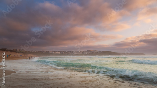 Golden pastel sunset over Fistral beach in Cornwall England