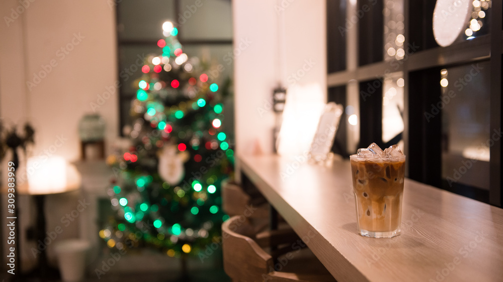 ice latte coffee in plastic cup put on wooden table, christmas theme background