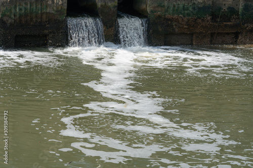 Dirty water flows from a pipe Sewage pipe polluting water