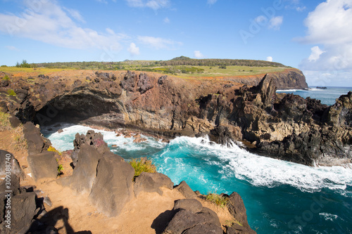A bay with Ana Kai Tangata cave along the coast of Easter Island, Chile