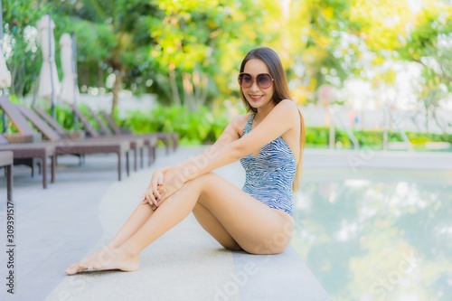 Free Download Beautiful young asian women happy smile relax around outdoor swimming pool in hotel resort for travel in holiday vacation - GFXLoad