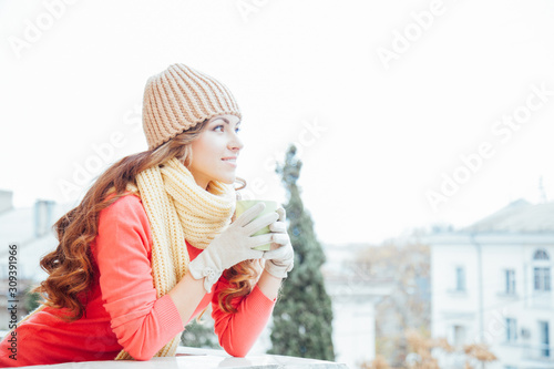 the girl in the hat froze and drinking hot tea