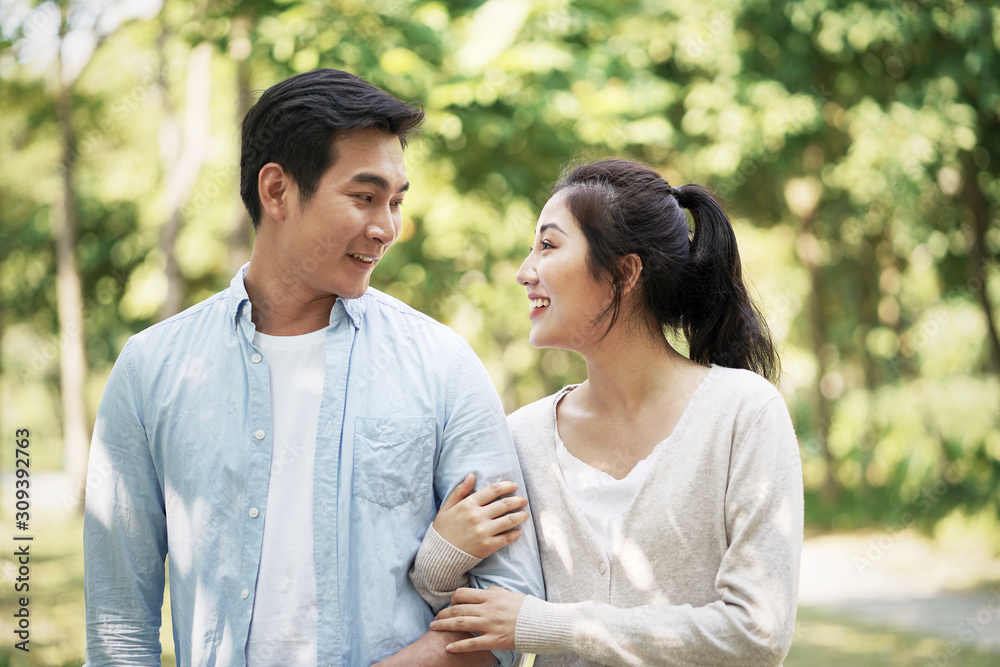 young asian couple relaxing outdoors young asian couple relaxing outdoors